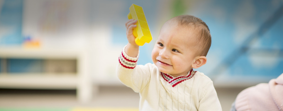 Little Boy at Daycare A baby boy playing with toys in a daycare / preschool setting.